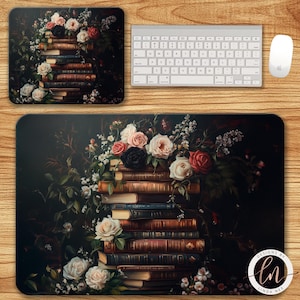 May include: A rectangular mouse pad and a square coaster feature a floral design with a stack of books and roses in shades of pink, red, and white. A white keyboard and mouse are also present. The design is set against a dark background.