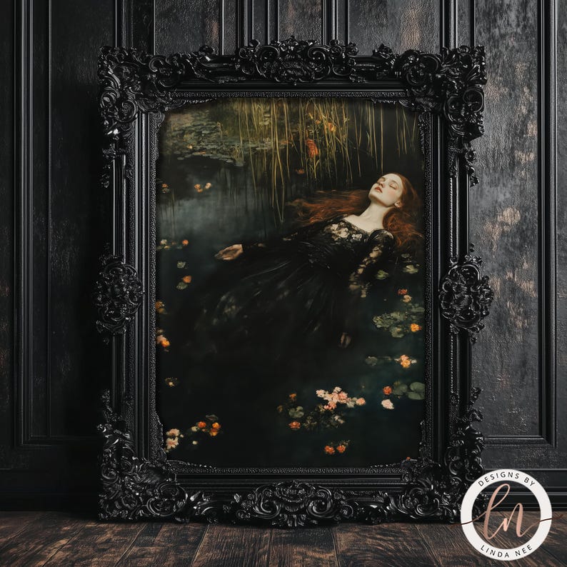 May include: A framed print of a woman in a black dress lying in a pool of water with flowers. The woman has long red hair and is wearing a black lace dress. The print is framed in a black ornate frame.