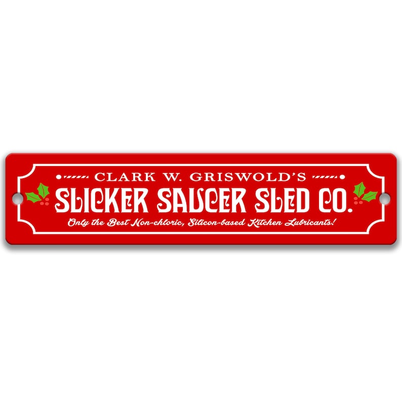 Puede incluir: Un letrero rojo con texto blanco que dice "... CLARK W. GRISWOLD'S ... SLICKER SAUCER SLED CO. Only the Best Non-chloric, Silicon-based Kitchen Lubricants!" con una rama de acebo verde a cada lado.
