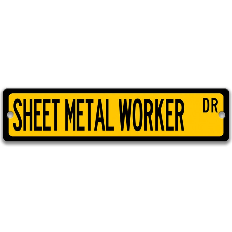 May include: A rectangular street sign with the words "SHEET METAL WORKER DR" in black capital letters on a yellow background. The sign has a black border and two mounting holes.
