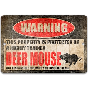Peut inclure: Un panneau d'avertissement noir et blanc avec du texte rouge qui dit "WARNING" dans un cercle. Le panneau indique "This property is protected by a highly trained deer mouse. Not responsible for injury or possible death." Une silhouette de souris est représentée sur le panneau.