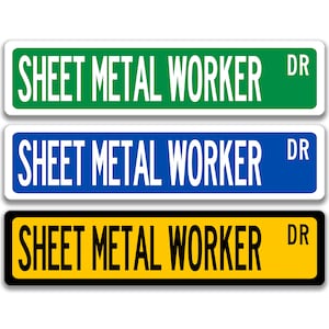 May include: Three rectangular street signs with the text "SHEET METAL WORKER DR". The signs have white backgrounds and black borders. The top sign is green, the middle sign is blue, and the bottom sign is yellow.