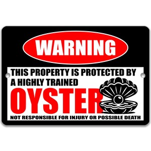 May include: Black rectangular sign with a red oval that says "WARNING". Below, text reads "THIS PROPERTY IS PROTECTED BY A HIGHLY TRAINED OYSTER" in black and red. A graphic of an oyster is on the right.