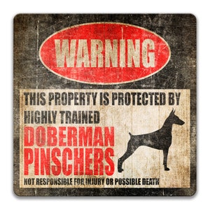 May include: A warning sign with a red circle and the word "WARNING" in white. The sign reads "This property is protected by highly trained Doberman Pinschers. Not responsible for injury or possible death." A black silhouette of a Doberman Pinscher is shown.