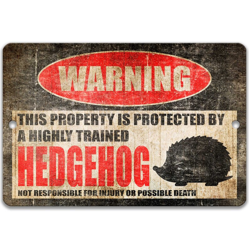 May include: A warning sign with a distressed, vintage look. It reads "WARNING THIS PROPERTY IS PROTECTED BY A HIGHLY TRAINED HEDGEHOG NOT RESPONSIBLE FOR INJURY OR POSSIBLE DEATH". The sign features a red circle with the word "WARNING" in white text. A black silhouette of a hedgehog is shown on the right side of the sign.