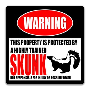 May include: A black and white warning sign with red text that reads "WARNING". The sign says "This property is protected by a highly trained skunk. Not responsible for injury or possible death." A black and white silhouette of a skunk is shown on the sign.