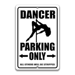 May include: White metal sign with black text and a silhouette of a woman on a pole. The sign reads "Dancer Parking Only. All others will be stripped."