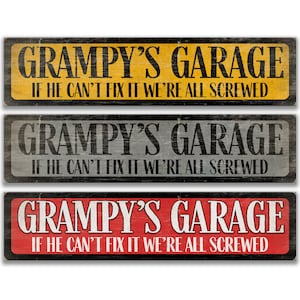 May include: Three wooden signs with black text that reads "Grampa's Garage" and "If he can't fix it we're all screwed". The signs are in yellow, gray, and red.