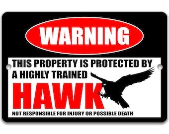 May include: Black and white sign with red text that reads "WARNING" in a red oval. The sign says "This property is protected by a highly trained HAWK. Not responsible for injury or possible death." A black silhouette of a hawk is flying in the middle of the sign.