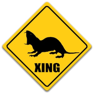 May include: A yellow diamond-shaped warning sign with a black silhouette of a rodent and the word "XING" in black letters.