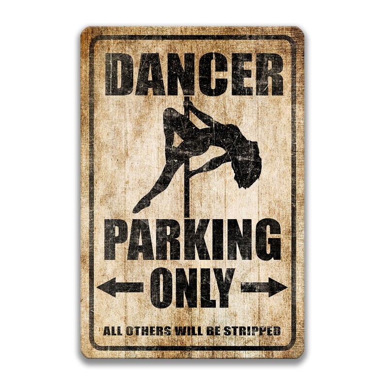 May include: A vintage-style metal sign with a distressed, brown background. The sign features a silhouette of a woman dancing on a pole, with the text "Dancer Parking Only" and the smaller text "All others will be stripped" below.