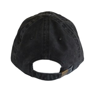 May include: A black cotton baseball cap with a curved brim and an adjustable strap.
