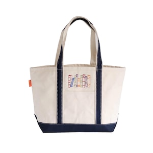 May include: A white ceramic mug with a black handle and the text "But First, Coffee" in a bold, black font. The mug is sitting on a wooden surface. The mug is approximately 4 inches tall.