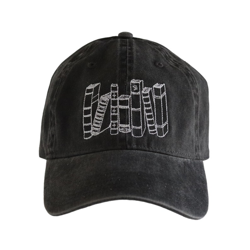 May include: A black baseball cap with a white embroidered design of a stack of books.