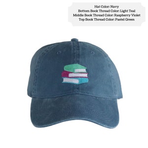 Navy blue baseball cap embroidered with three books stacked on top of each other.