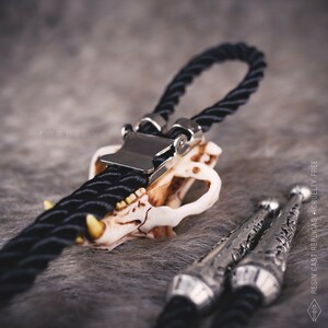 Back of the bear skull bolo tie showing the adjustable slide clip and durable black braided cord, high-quality western jewelry.