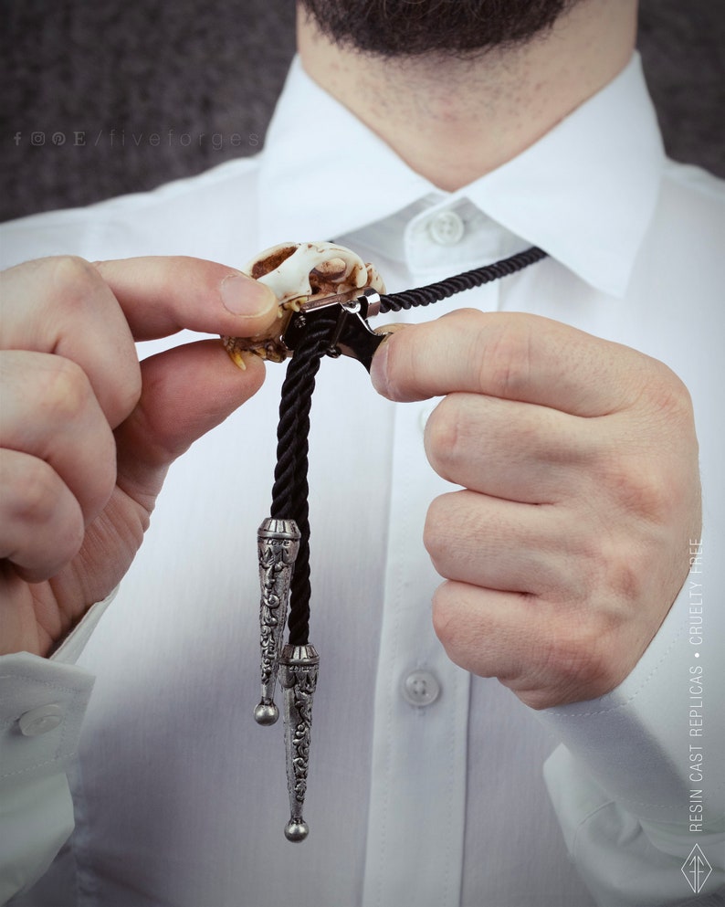 Back of the cat skull bolo tie showing the adjustable slide clip and durable black cord, handmade cruelty-free taxidermy jewelry.