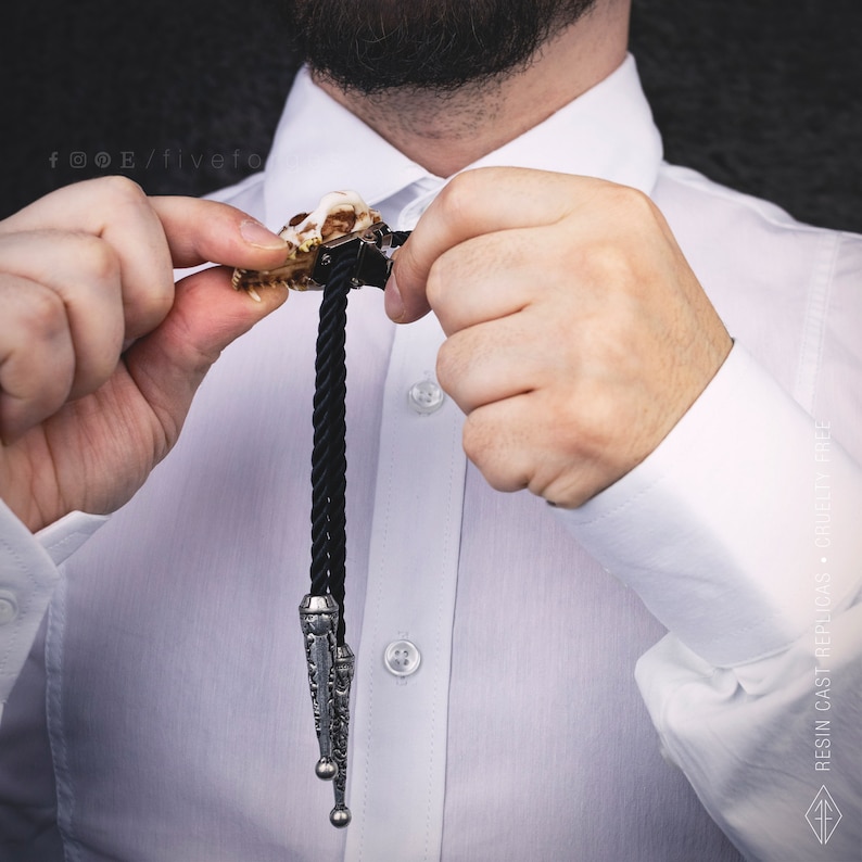 Back of the bear skull bolo tie showing the adjustable slide clip and durable black braided cord, high-quality western jewelry.