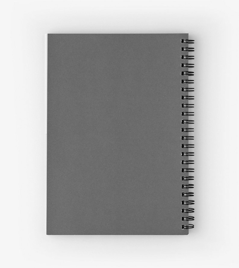 May include: A gray spiral-bound notebook with a solid cover. The notebook has a matte finish and a black spiral binding along the spine. The pages are not visible.