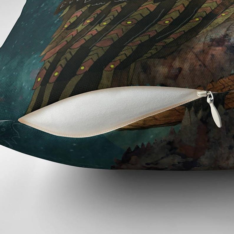 May include: Decorative throw pillow featuring a detailed illustration of a fantastical creature with intricate patterns in shades of brown, gold, and green. The pillow has a dark teal background and a visible zipper.