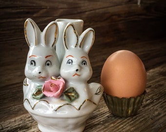 A Small Ceramic Vase With Two Rabbit