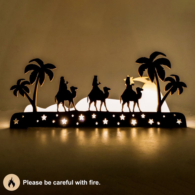 Christmas decoration - three wise kings laser cut. This is the scene where the three wise men bring gifts to the baby Jesus. The decoration was photographed in the dark with lighting inside the decoration. Please be careful with fire.