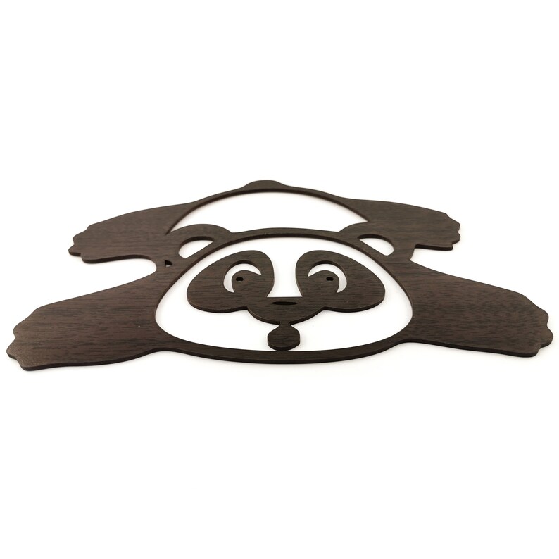 Wall art pandas - a fallen panda figure is laser cut and made of wood.