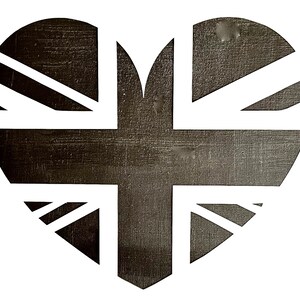 May include: A black and white heart-shaped design with the Union Jack flag pattern. The design is on a white background.