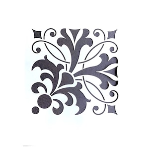 May include: Black and white floral design stencil with a repeating pattern of stylised leaves and swirls.