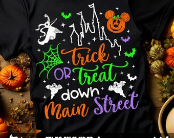May include: Black Halloween-themed t-shirt with the words "Trick or Treat down Main Street" in orange, green, and purple. The design includes a jack-o'-lantern, ghosts, bats, and a spider web. The shirt is a festive apparel item.