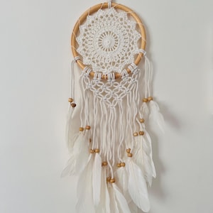 White dreamcatcher with feathers.