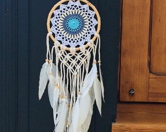 Cute dreamcatcher with feathers and wooden frame.