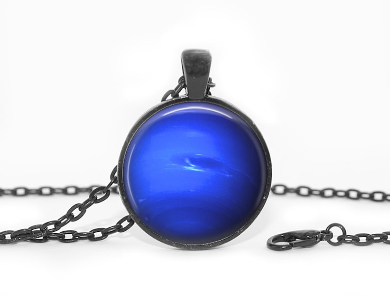 May include: A black chain necklace with a round pendant featuring a blue image of the planet Jupiter.