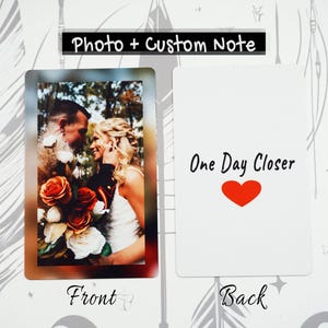May include: A personalized photo card with a wedding photo on the front and the text "One Day Closer" with a red heart on the back. The front of the card has the word "Front" and the back has the word "Back".