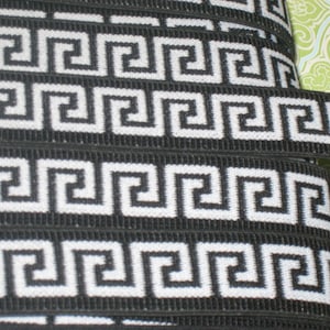 May include: Black and white elastic trim with a Greek key pattern.