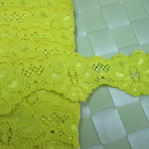 6 yards 1 1/2&quot; width shimmery with scallop in lemon yellow color stretch lace trim for your fashion design and sewing project.