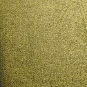 May include: A close-up of a textured fabric in a muted olive green color.