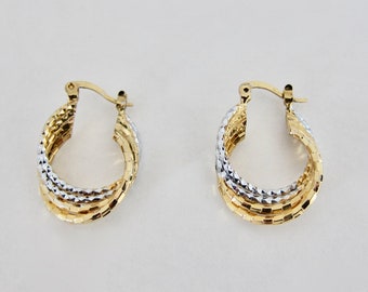 1980, 2-tone gold-plated twisted hoop earrings. Signed.