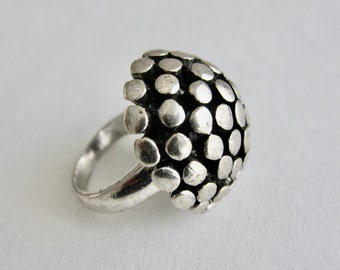 1980, studded ball ring in silver metal. Unsigned.