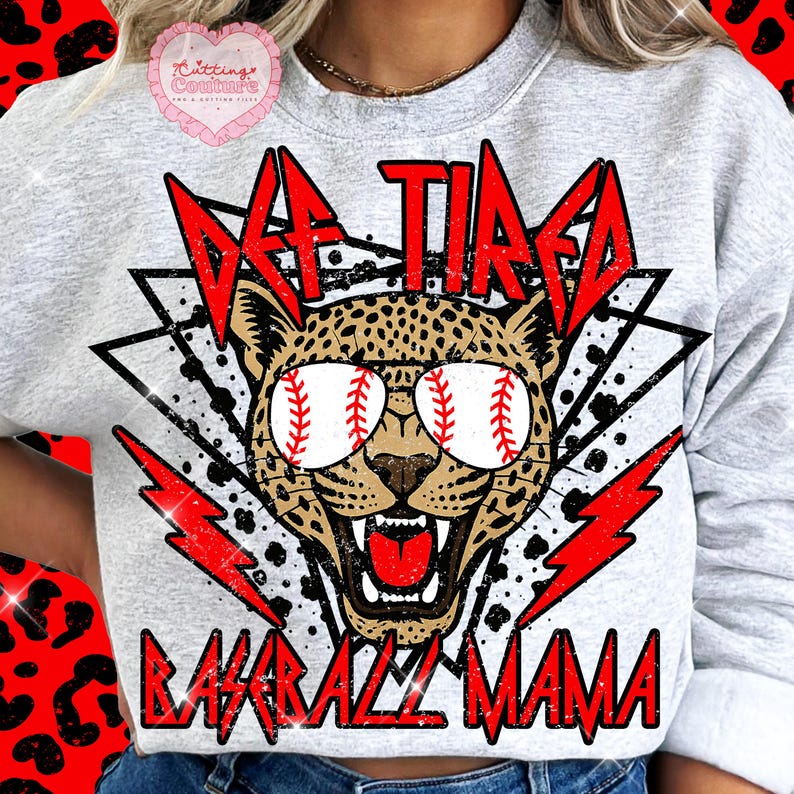 May include: A light gray sweatshirt with the text "DF TIRED BASEBALL MAMA" in red. The design features a leopard wearing baseball-themed sunglasses, with red lightning bolts and geometric shapes.