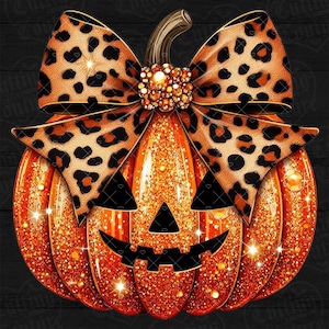 May include: A glittery orange jack-o'-lantern pumpkin featuring a large leopard print bow tied at the stem. The pumpkin has a carved black triangular nose and a jagged black mouth, with a cluster of gold-toned beads at the center of the bow.