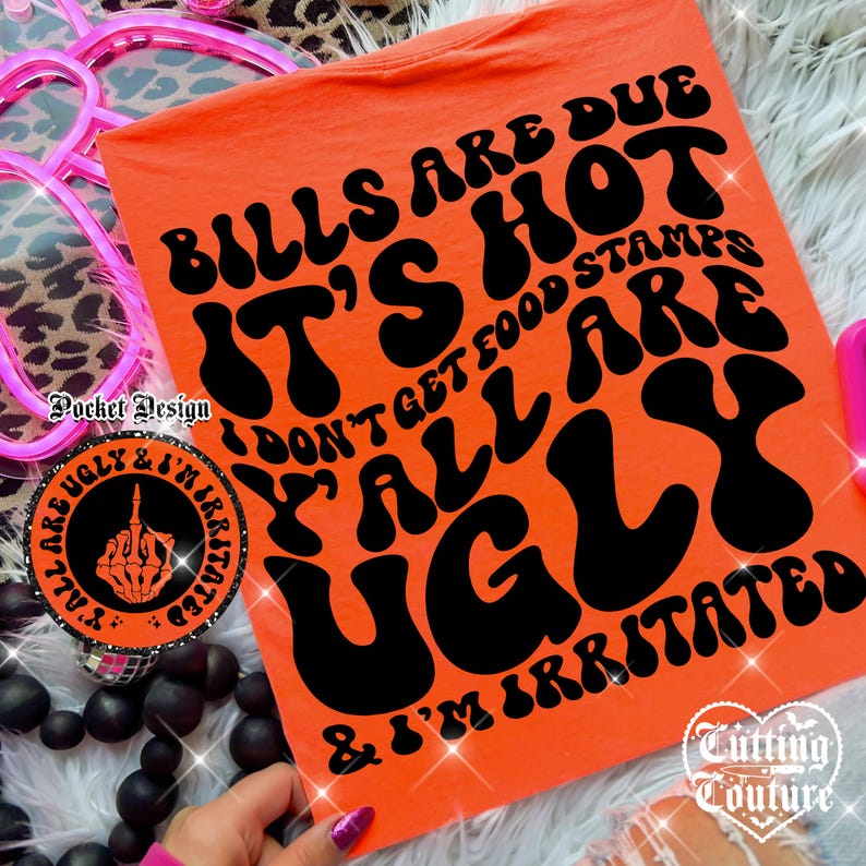 May include: An orange t-shirt with the text "Bills are due, it's hot, don't get food stamps, y'all are ugly & I'm irritated" in black. A round sticker with a hand giving the middle finger is also visible.