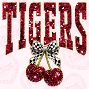 May include: A digital graphic with the word "TIGERS" in red sequined letters outlined in gold. Below the word is a black and white checkered bow and two red jeweled cherries. The background is light pink.