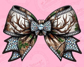 May include: A decorative bow featuring a camouflage pattern with brown antler accents. The bow is embellished with sparkling rhinestones and a central jewel. The background is a light pink color with the text "Cutting Couture" repeated.