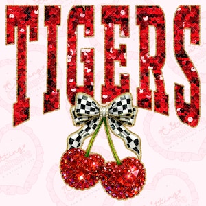 May include: A graphic design featuring the word "TIGERS" in red sequined letters with gold trim. Below the text is a bow with a black and white checkered pattern and two red jeweled cherries.