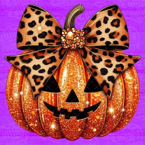 May include: A glittery orange jack-o'-lantern pumpkin featuring a large leopard print bow tied at the stem. The bow is accented with a cluster of golden beads at the center. The pumpkin has a carved black triangular nose and a jagged black mouth.