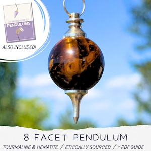May include: A spherical tourmaline and hematite pendulum with a silver-toned metal cap and pointed base. The stone features dark brown and black swirling patterns. Included is a digital guide titled A Curious Guide to Pendulums.