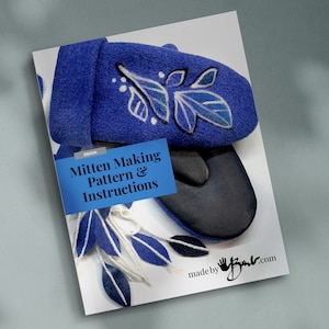 May include: Ebook cover featuring a blue mitten with a white floral design. The title of the ebook is "Mitten Making Pattern & Instructions" and the text "made by" is visible at the bottom of the cover.