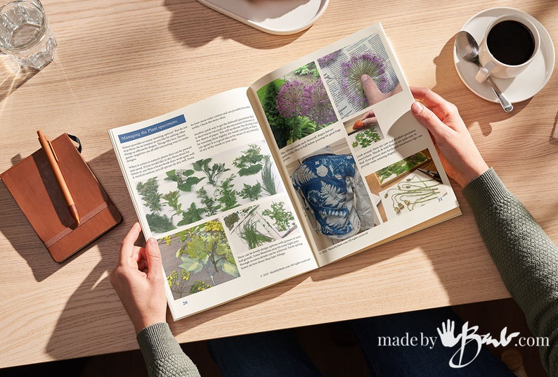 May include: An open book with instructions on how to manage plant specimens for crafting. The book features images of various plants and a finished fabric project with a blue and white pattern.