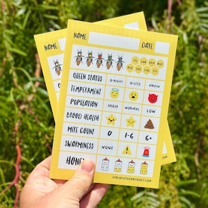 May include: A yellow rectangular beekeeping hive inspection card featuring a grid with categories for queen status, temperament, population, brood health, mite count, swarminess, and honey, with icons and text including the website girlnextdoorhoney.com.